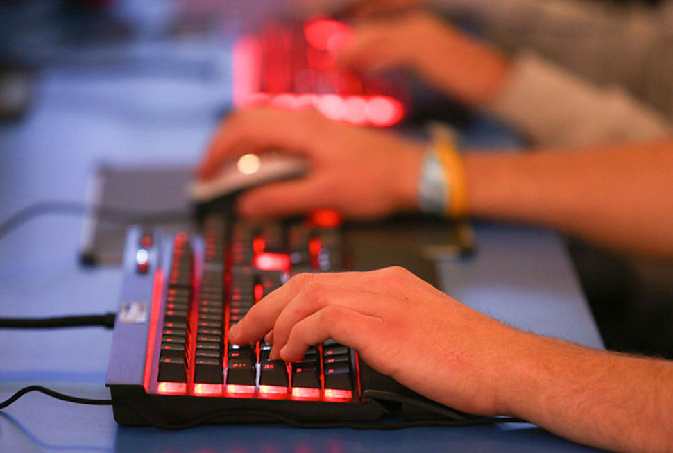 Visitos use keyboards to play computer games during the EGX gaming conference at Earls Court in London, U.K., on Thursday, Sept. 25, 2014. Sony Corp. will begin selling its PlayStation TV set-top box in the U.S. and Europe next month with almost 700 games available, including select Angry Birds, Borderlands, Lego and FIFA soccer titles. Photographer: Chris Ratcliffe/Bloomberg via Getty Images