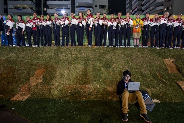 RIO DE JANEIRO, BRAZIL - AUGUST 03: A journalist works on his computer as Team Russia athletes for the Rio 2016 Olympic Games attend their welcome ceremony at the Athletes village on August 3, 2016 in Rio de Janeiro, Brazil. (Photo by David Ramos/Getty Images)