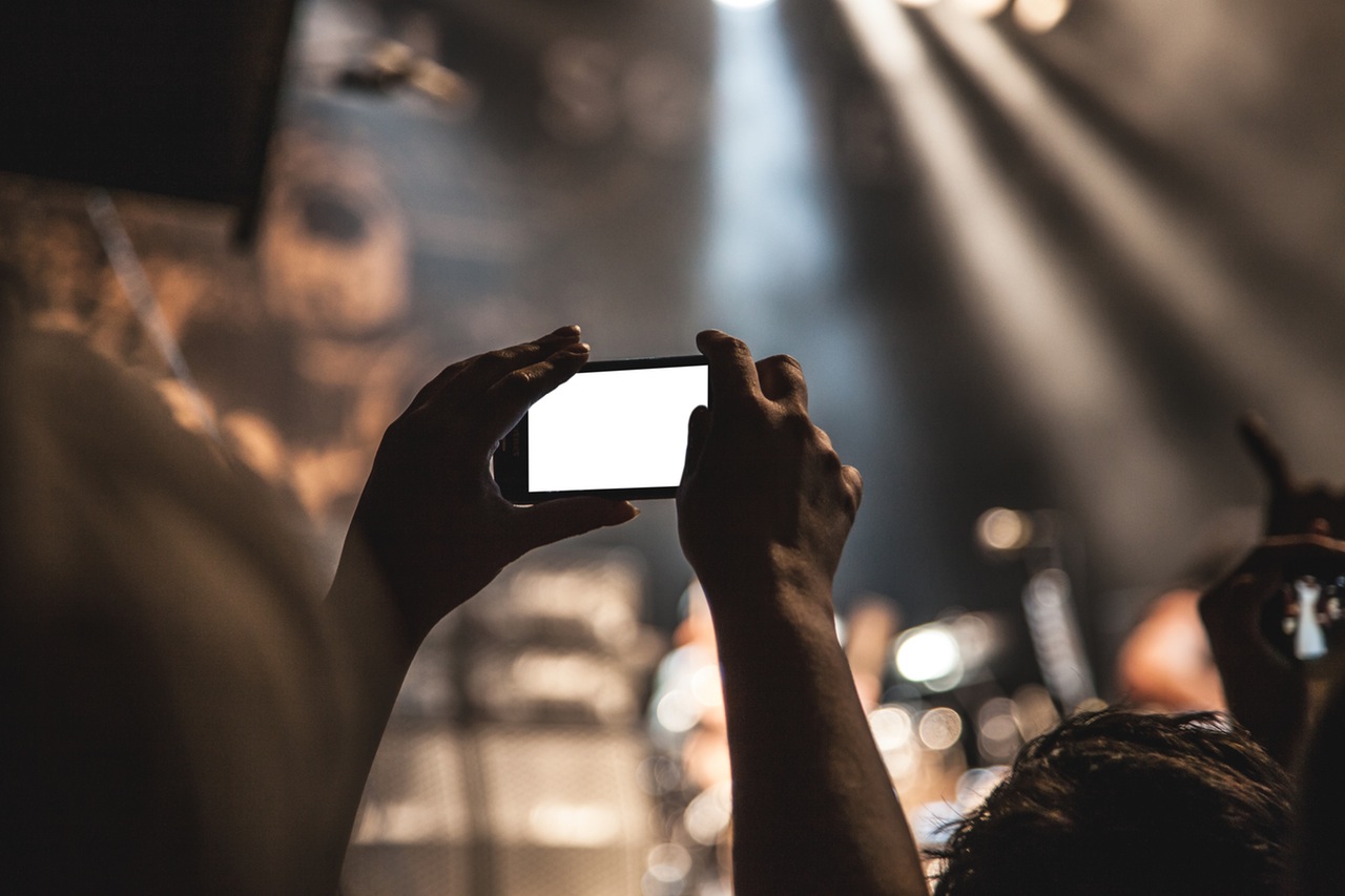 hands-smartphone-taking-photo-festival