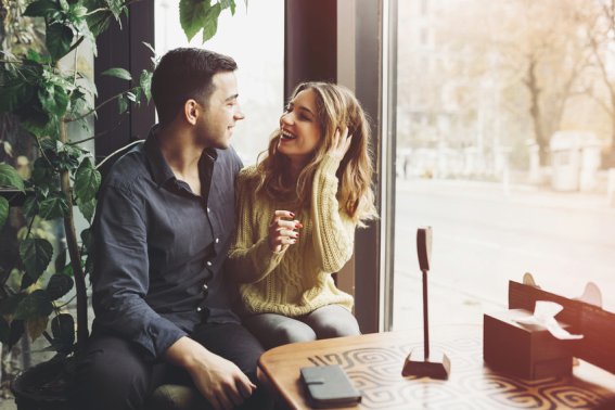 Couple in love drinking coffee and have fun in coffee shop. Love concepts. Vintage effect style picture