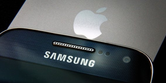 LONDON, ENGLAND - AUGUST 06: A Samsung and Apple smartphone are displayed on August 6, 2014 in London, England. Smartphone and tablet manufacturers Samsung and Apple have agreed to end all legal cases over patent infringements outside of the US.  (Photo by Peter Macdiarmid/Getty Images)