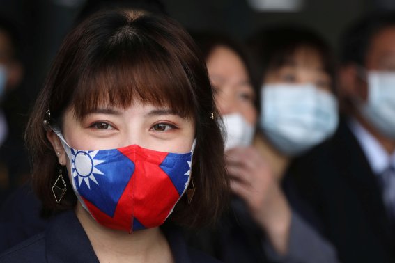 A staff wears a face mask with a Taiwanese flag design, as protection due to the coronavirus disease (COVID-19) outbreak, at a factory for non woven filter fabric used to make surgical face masks, in Taoyuan, Taiwan, March 30, 2020. REUTERS/Ann Wang