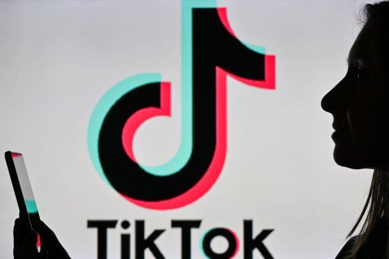 An image of a woman holding a cell phone in front of a TikTok logo displayed on a computer screen.
On Tuesday, January 12, 2021, in Edmonton, Alberta, Canada. (Photo by Artur Widak/NurPhoto via Getty Images)