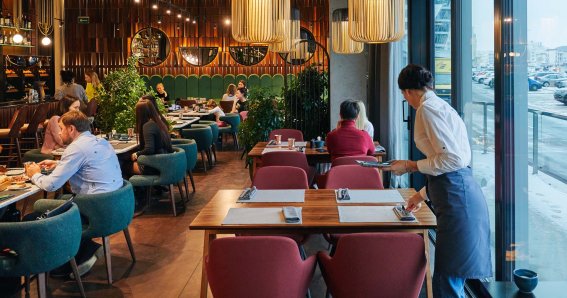 Waiter serving table in the restaurant